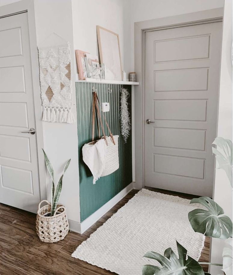Wall-mounted storage design to save space in a small entrance lobby