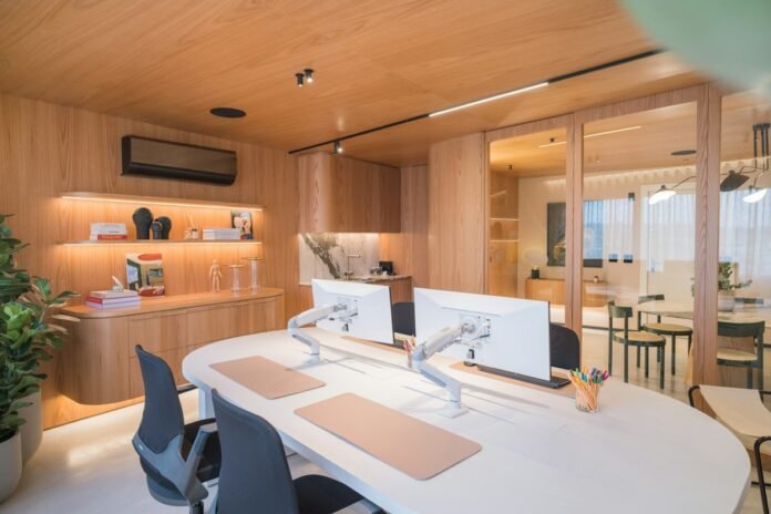 Modern ergonomic home office workstation with dual monitor setup wooden accents and task lighting