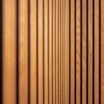 Modern acoustic wood slat wall paneling installed in a home office workspace for sound absorption