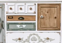 Upcycled Thrifted Furniture Painting and Distressing Techniques for Vintage Charm Vintage upcycled wooden cabinet with painted body natural wood tabletop and distressed antique detailing