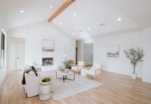 Engineered Hardwood vs Luxury Vinyl Plank Durability and Cost Comparison for Homes Bright contemporary living room featuring open concept natural wood plank flooring with modern furniture