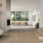 Modern luxury open concept living room featuring expansive large format polished porcelain floor tiles