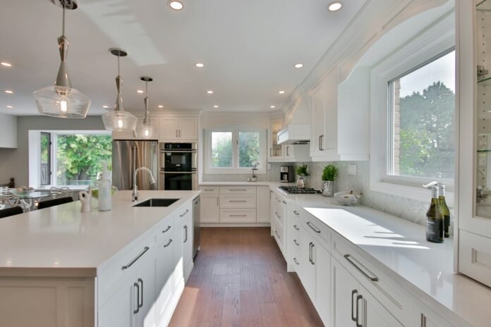 Load-Bearing Wall Removal and Open-Concept Kitchen Structural Remodeling Guidelines Renovated modern open concept kitchen with spacious island where a load bearing wall was removed