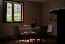 Energy-Efficient Window Replacements and Thermal Insulation Upgrades for Older Homes High efficiency energy saving double glazed window in an older renovated home dining room with bright natural lighting