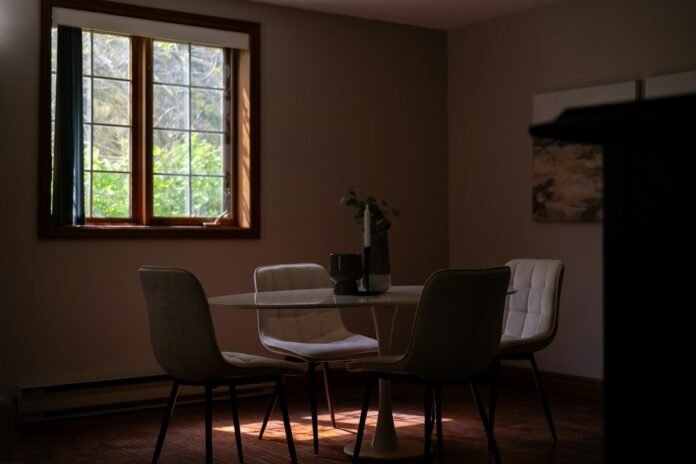 Energy-Efficient Window Replacements and Thermal Insulation Upgrades for Older Homes High efficiency energy saving double glazed window in an older renovated home dining room with bright natural lighting