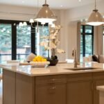 Open plan living and dining space with elegant pendant lights layered ceiling illumination and warm ambient lighting