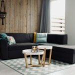 Handwoven wool area rug anchoring a modern living room seating arrangement with sectional sofa coffee table and warm hardwood flooring