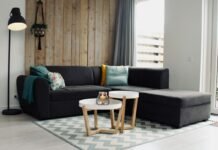 Handwoven Wool Area Rug Placement Rules for Anchoring Living Room Seating Handwoven wool area rug anchoring a modern living room seating arrangement with sectional sofa coffee table and warm hardwood flooring