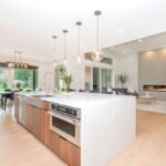 Luxury kitchen island featuring durable engineered quartz and natural granite countertop with modern cabinetry