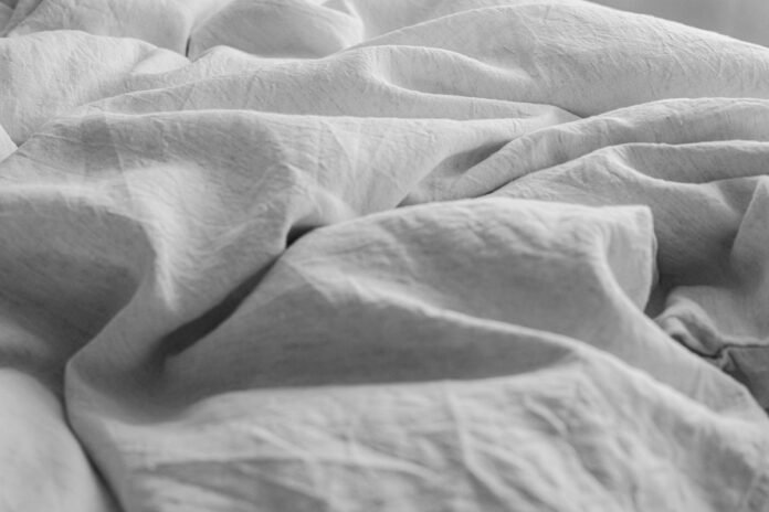 Organic Linen Bedding Styling Essentials for Breathable Year-Round Sleeping Organic linen bedding styling essentials layered in a serene modern master bedroom
